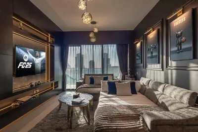 a living room with a couch and a tv at Brand New LUXE Downtown Dubai 46th Floor in Dubai