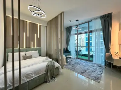 a bedroom with a bed and a large window at Stylish Studio with Stunning Marina Canal Views near to the Beach in Dubai