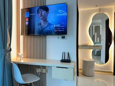 a room with a desk with a tv on a wall at Stylish Studio with Stunning Marina Canal Views near to the Beach in Dubai