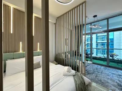 a bedroom with a bed and a large window at Stylish Studio with Stunning Marina Canal Views near to the Beach in Dubai