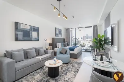 a living room with a couch and a table at Vogue JVC Binghatti Galaxy near Circle Mall, Studio Apartment with Balcony and City View, Access to all Amenities in Dubai
