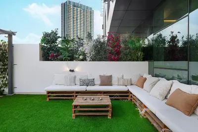 a living room with a couch and a coffee table on a patio at Downtown Views - For Big families & Groups - Up to 13 Guests - 6 min from Burj Khalifa in Dubai