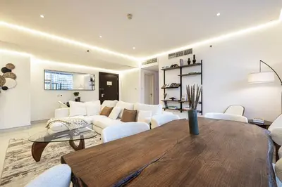 a living room with a couch and a table at Downtown Views - For Big families & Groups - Up to 13 Guests - 6 min from Burj Khalifa in Dubai