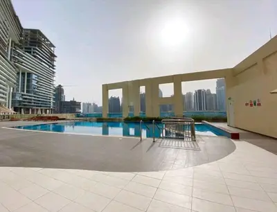a large swimming pool in the middle of a city at Great & huge apartment high floor! in Dubai