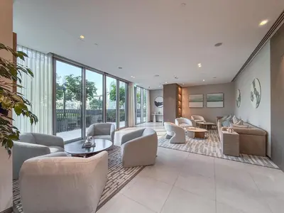a living room with chairs and tables and windows at Hermes-Style 2BR, Full Burj Khalifa View - Infinity Pool - Full Fountain View in Dubai