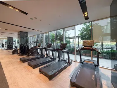 a gym with a row of treadmills at Hermes-Style 2BR, Full Burj Khalifa View - Infinity Pool - Full Fountain View in Dubai