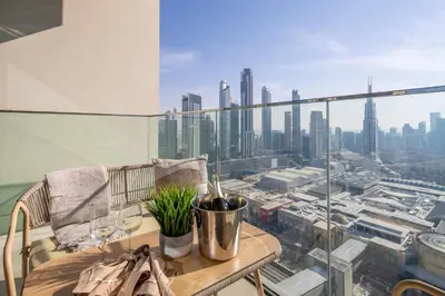 a balcony with a table and a view of a city at Frank Porter - Downtown Views in Dubai