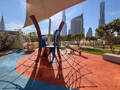 a sculpture of a playground with a city in the background at Frank Porter - Downtown Views in Dubai