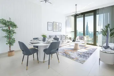 a white living room with a table and chairs at Frank Porter - Downtown Views in Dubai
