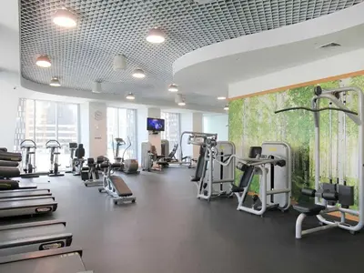 a gym with several treadmills and cardio machines at Frank Porter - Cayan Tower in Dubai