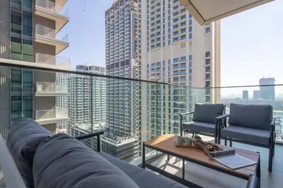 a balcony with a couch and chairs and a table at Frank Porter - Beach Vista Tower 2 in Dubai