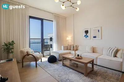 a living room with a couch and a table at HiGuests - Elegant 1BR Retreat with Sea View in La Rive in Dubai