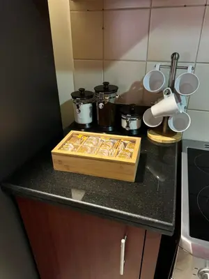 a kitchen counter with a wooden cutting board on it at Best view homes in Dubai