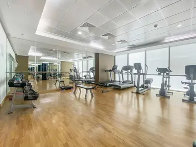 a gym with treadmills and exercise equipment in a room at Silkhaus Comfy Studio in Liberty House DIFC Heart in Dubai
