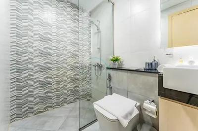 a bathroom with a shower and a toilet and a sink at Community View 1BR with Balcony Near Downtown Dubai, Binghatti Avenue, Al Jaddaf by Deluxe Holiday Homes in Dubai