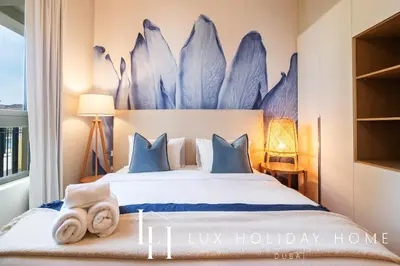 a bedroom with a bed with towels on it at LUX The La Mer Luxury Burj View Suite 3 in Dubai