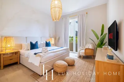 a bedroom with a bed and a tv in it at LUX The La Mer Luxury Burj View Suite 3 in Dubai