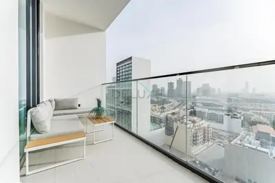a white room with a view of a city at City Views 1BR with Private Balcony, Binghatti House, Jumeirah Village Circle by Deluxe Holiday Homes in Dubai