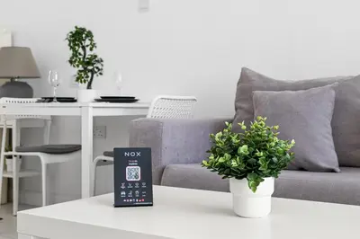 a remote control sitting on a table next to a couch at Studio Palm Views West, Palm Jumeirah in Dubai