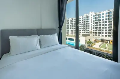 a bedroom with a white bed and a large window at Pure Voyage Town Square in Dubai