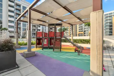a playground with a slide in a building at GuestReady - Riviera Studio | Burj Khalifa view in Dubai