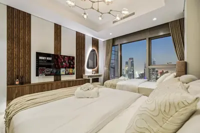 a bedroom with two beds and a large window at The Highest Infinity Pool in Downtown Dubai in Dubai