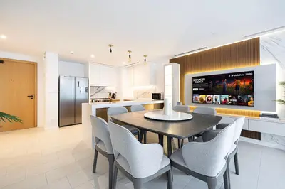 a kitchen and dining room with a table and chairs at La Vie in JBR! Private Beach! Excellent Apartments! in Dubai