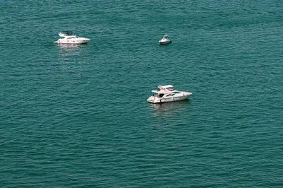 three boats in a large body of water at La Vie in JBR! Private Beach! Excellent Apartments! in Dubai