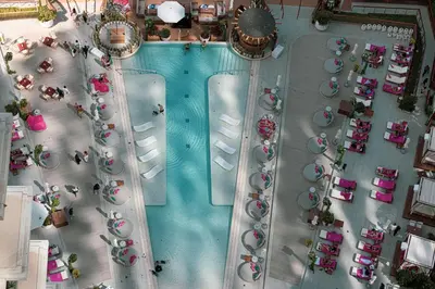 an overhead view of a swimming pool with a group of cars at La Vie in JBR! Private Beach! Excellent Apartments! in Dubai