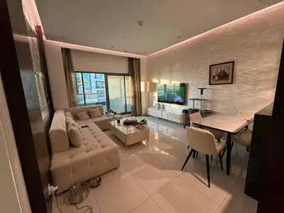 a living room with a couch and a table at Bright and Airy 2BR Bay Retreat in Dubai