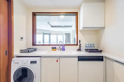 a kitchen with a sink and a washing machine at SuperHost EMAAR Residences - Former Address Dubai Mall in Dubai