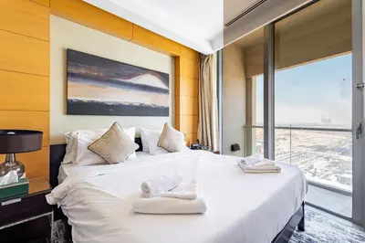 a bedroom with a large white bed with a large window at SuperHost EMAAR Residences - Former Address Dubai Mall in Dubai