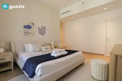 a bedroom with a large bed in a room at HiGuest - Stylish 1BR Apartment in La Mer in Dubai