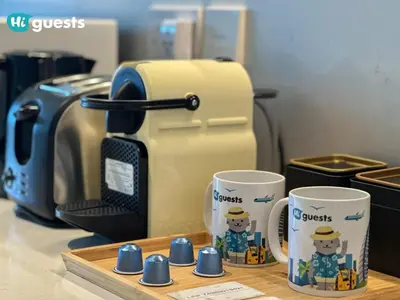 a table with two coffee cups and a toaster at HiGuest - Stylish 1BR Apartment in La Mer in Dubai
