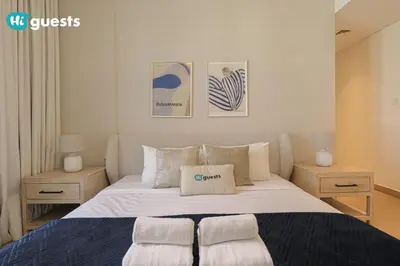 a bedroom with a large bed with two night stands at HiGuest - Stylish 1BR Apartment in La Mer in Dubai