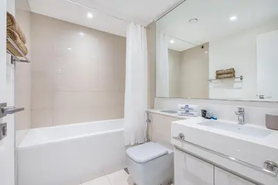 a bathroom with a toilet and a sink and a tub at Premium Home in Park Point Near Dubai Hills Mall in Dubai