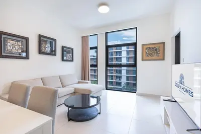 a living room with a couch and a table at Premium Home in Park Point Near Dubai Hills Mall in Dubai