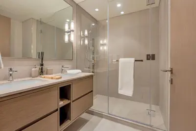 a bathroom with a glass shower and a sink at Downtown Luxury 2BR - Full Burj Khalifa & Fountain Views - 5 Minutes Walk to Dubai Mall in Dubai
