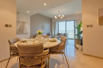 a dining room with a table and some chairs at Downtown Luxury 2BR - Full Burj Khalifa & Fountain Views - 5 Minutes Walk to Dubai Mall in Dubai