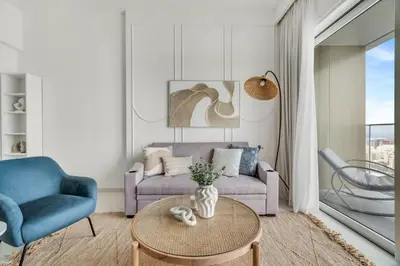 a living room with a couch and a table at GuestReady - Amazing home with a Great sea view in Dubai