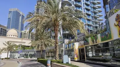 a palm tree in front of a tall building at Condor Marina Star Seaview Studio, Dubai Marina in Dubai