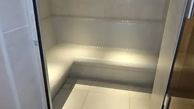 a small refrigerator with its door open in a bathroom at Condor Marina Star Seaview Studio, Dubai Marina in Dubai