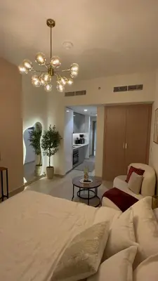 a bedroom with a bed and a living room at AMLY holiday home DUBAI in Dubai