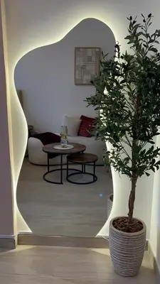 a living room with a potted tree and a couch at AMLY holiday home DUBAI in Dubai