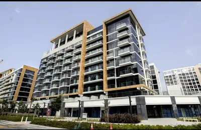 a large apartment building with balconies in a city at AMLY holiday home DUBAI in Dubai