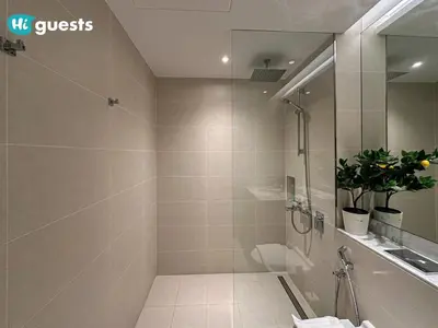 a bathroom with a shower and a toilet and a sink at HiGuest - Elegant 1BR Oasis in La Mer in Dubai