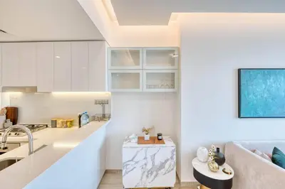 a kitchen and living room with a couch and a table at Classic BNB - Ahad Large 1BR for 4 in Dubai