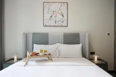 a bed with a tray of fruit on top of it at Livbnb-Embrace Luxury and Comfort in Prime 1BR,JLT in Dubai