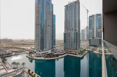 a view of a river in a city with tall buildings at Livbnb-Embrace Luxury and Comfort in Prime 1BR,JLT in Dubai