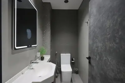 a bathroom with a sink and a toilet and a mirror at Livbnb-Embrace Luxury and Comfort in Prime 1BR,JLT in Dubai